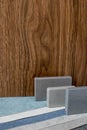 Close up combination of interior material containing set of artficial stone and wooden veneer samples. quartz stone and wooden