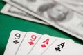 Two pair of aces and nines during poker with dollars on green table Royalty Free Stock Photo