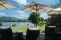 Comfortable sofa with outdoor garden parasol in bright sunny day for rest in summer