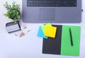 Close-up of comfortable working place in office with laptop, notebook, glasses, pen and other equipment laying on table Royalty Free Stock Photo