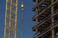 Close up of commercial office building under construction with construction worker ,crane, steel beams with weight of steel beams Royalty Free Stock Photo