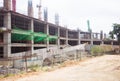 Close up of commercial office building under construction with construction workers. Royalty Free Stock Photo