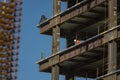 Close up of commercial office building under construction with construction workers ,steel beams with weight of steel beams sprypa Royalty Free Stock Photo