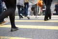 Close Up Of Commuters Feet Crossing Busy Street