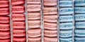 Colorful background of rows of french macaroons. Close up of macaroon cookies