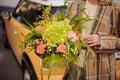 Close-up of composition of different flowers in the hands of woman