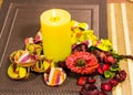 Close up of a composition - glass and bottle of wine, decorating flowers and leaves on a table