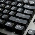 Close up of a computer keyboard featuring black keys with white lettering Royalty Free Stock Photo