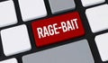 Close-up of a computer keyboard with a prominent red key featuring the white text RAGE-BAIT, symbolizing online provocation Royalty Free Stock Photo