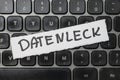 A close-up of a computer keyboard with a white label marked DATENLECK highlighting the concept of data leaks or breaches Royalty Free Stock Photo