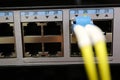 Close up of a computer network fiber optic cable connected to a switch Royalty Free Stock Photo