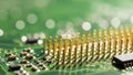 Close-up of a computer processor with gold pins on a green circuit board, showcasing advanced technology and microelectronics Royalty Free Stock Photo
