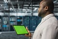 Close up of computer scientist in data center using green screen tablet Royalty Free Stock Photo