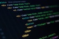 close-up of computer screen with colorful html code, focus on div and button elements, web development and frontend design