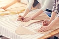 Close up of concentrated tailors creating clothing patterns