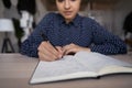 Close up concentrated young female Indian business woman handwriting notes. Royalty Free Stock Photo