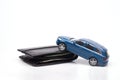 Close-up conceptual image of a blue toy car on a black wallet representing car loans, debts and related expenses. credit and