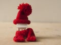 Close up conceptual miniature model house with red wool scarf hat on wooden background Royalty Free Stock Photo