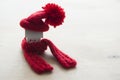 Close up conceptual miniature model house with red wool scarf hat on wooden background Royalty Free Stock Photo