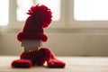 Close up conceptual miniature model house with red wool scarf hat on wooden background Royalty Free Stock Photo