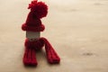 Close up conceptual miniature model house with red wool scarf hat on wooden background Royalty Free Stock Photo