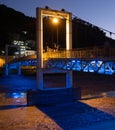Close Up of the Concrete Support of Berat`s Suspension Bridge Lit in Blue and Gold