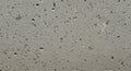 A close-up of a concrete surface displaying a rough texture with scattered small Royalty Free Stock Photo