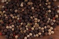 Close up of condiment on brown wooden background. Bunch of different peppers on table with space for your text.