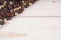 Close up of condiment on white wooden background. Bunch of different peppers on table with space for your text. Royalty Free Stock Photo