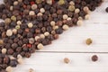 Close up of condiment on white wooden background. Bunch of different peppers on table with space for your text.