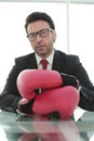 Close up.confident businessman Boxing gloves sitting at his Desk Royalty Free Stock Photo