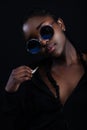 Cool woman with dark skin wearing round sunglasses Royalty Free Stock Photo