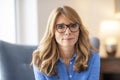 Close-up of confident middle aged woman looking at camera  while relaxing indoor Royalty Free Stock Photo