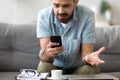 Close up confused man having problem with phone, receive bad news Royalty Free Stock Photo