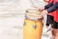 Close up of conga drums with man`s hands holding drumsticks set on concrete floor in a stadium for cheer. Royalty Free Stock Photo