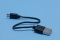 close up of Connector micro-USB, USB with cable, isolated on blue background. Royalty Free Stock Photo
