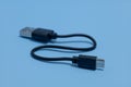 close up of Connector micro-USB, USB with cable, isolated on blue background. Royalty Free Stock Photo