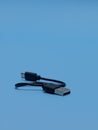 close up of Connector micro-USB, USB with cable, isolated on blue background. Royalty Free Stock Photo