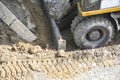 Close-up of construction equipment. Soil extraction by excavator. Improvement and construction, road works. Works on landscaping Royalty Free Stock Photo