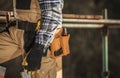 Close Up Of Construction Laborer With Tool Belt Around Waist