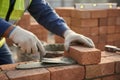 Close-up of a construction worker building a brick wall with mortar Royalty Free Stock Photo
