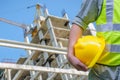 Close-up construction worker holding hard hat with background of Royalty Free Stock Photo