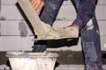 Close-up of the construction worker is mixing cement for plastering for the house.