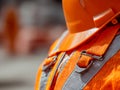 Detailed view of safety harness and helmet worn by construction worker ensuring secure protective gear and hazard prevention at Royalty Free Stock Photo