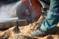 Close-up of a construction worker working with a circular saw, cutting a concrete block. Royalty Free Stock Photo