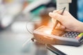 Close-up of consumer`s women hand signing on a touch screen of credit card sale transaction receipt machine at supper market Royalty Free Stock Photo