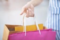 Close up of consumerism young woman holding hand many shopping bag in fashion boutique after buying presents while walking along t Royalty Free Stock Photo