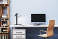 Close up of contemporary designer office interior with creative wooden bookcase, empty computer monitor and other items. Royalty Free Stock Photo