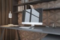 Close up of contemporary home office interior with workplace, decorative designer wall, reflections on computer monitor and