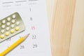 Close up Contraceptive control pills on date of calendar background. Royalty Free Stock Photo